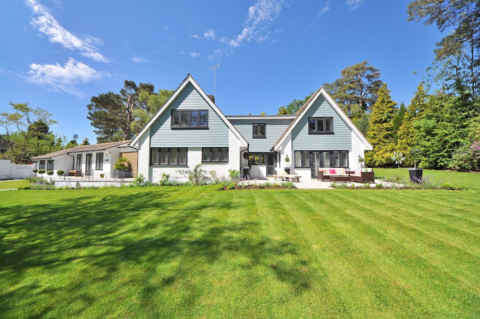 Residential home with a green lawn and mature trees in the front yard